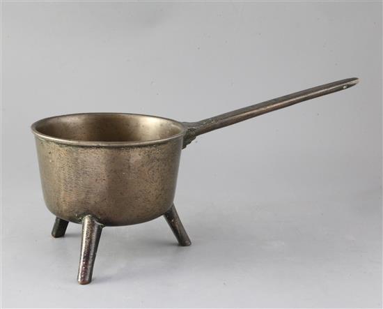 An 18th century bronze skillet, height to tip of handle 8in., length 16.5in.